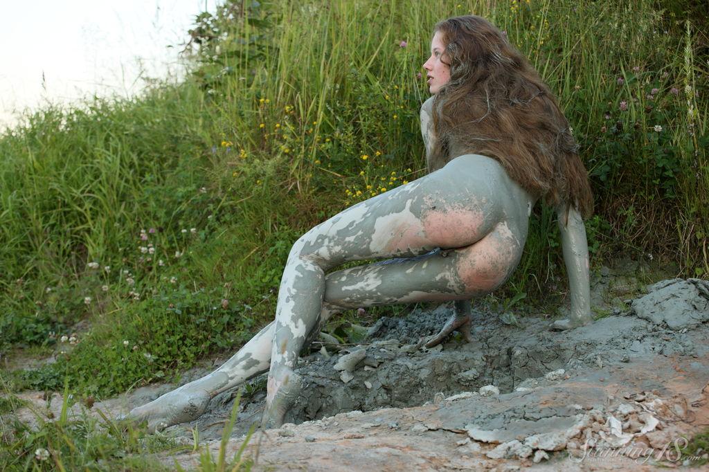 Pretty teen Nicole K rolls around in the mud outside #61931095