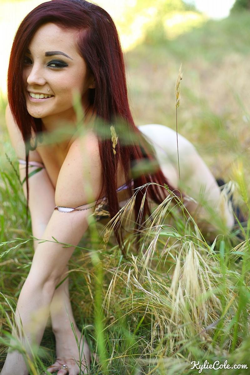 Redhead teen Kylie Cole strips and teases in the field #58784263
