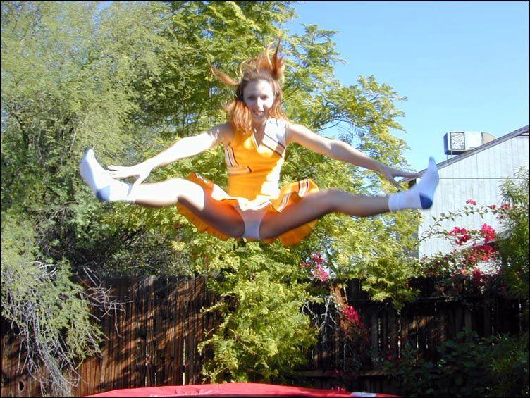 Pictures of two cheerleaders on a trampoline #60578448