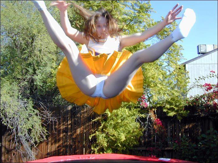 Pictures of two cheerleaders on a trampoline #60578459