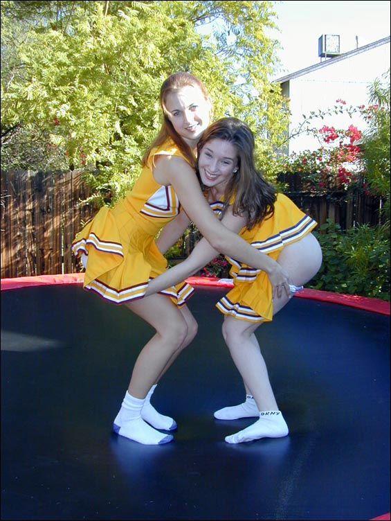 Pictures of two cheerleaders on a trampoline #60578535