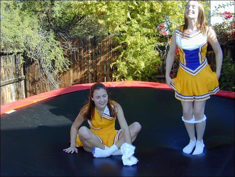 Pictures of two cheerleaders on a trampoline #60578568