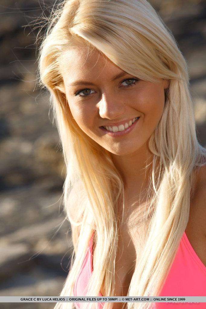 Photography of tight blonde woman Grace C getting naked on a seaside