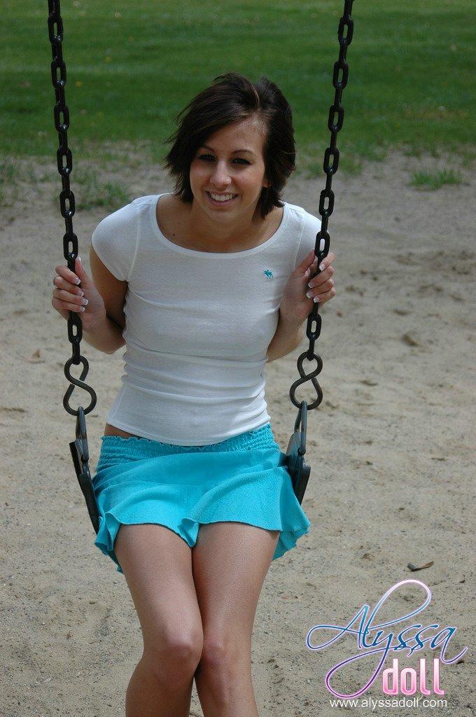 Alyssa teases on a swing in a park #53053966