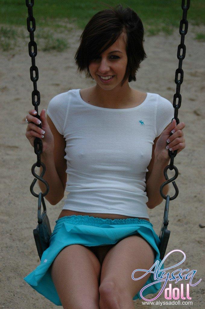 Alyssa teases on a swing in a park #53054081