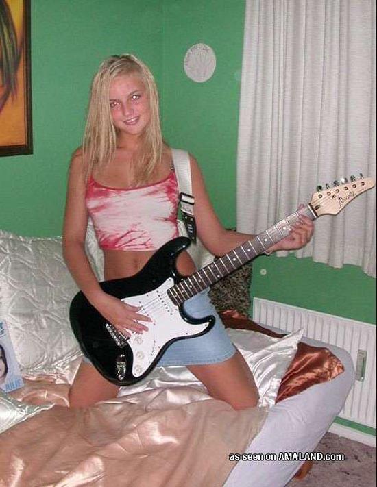 Blonde rockstar cutie posing with her guitar #60657695